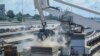 FILE - Grain is offloaded from a ship in the port of Mombasa, Kenya, on Nov. 26, 2022. Global prices for food commodities like grain and vegetable oils were the highest on record last year, exacerbating the high cost of living for low-income Kenyans.