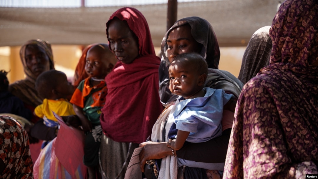 FILE - Women and babies are seen at the Zamzam displacement camp, home to 400,000, in North Darfur, Sudan, in January 2024. Doctors Without Borders found two babies were dying every hour there, and nearly 40% of children 6 months to 2 years old were malnourished.