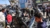 FILE - People check a car in which two journalists, Mustafa Thuria, a video stringer for news service Agence France-Presse, and Hamza Wael Dahdouh, a journalist with Al Jazeera television network, were killed in the Gaza Strip on Jan. 7, 2024. 