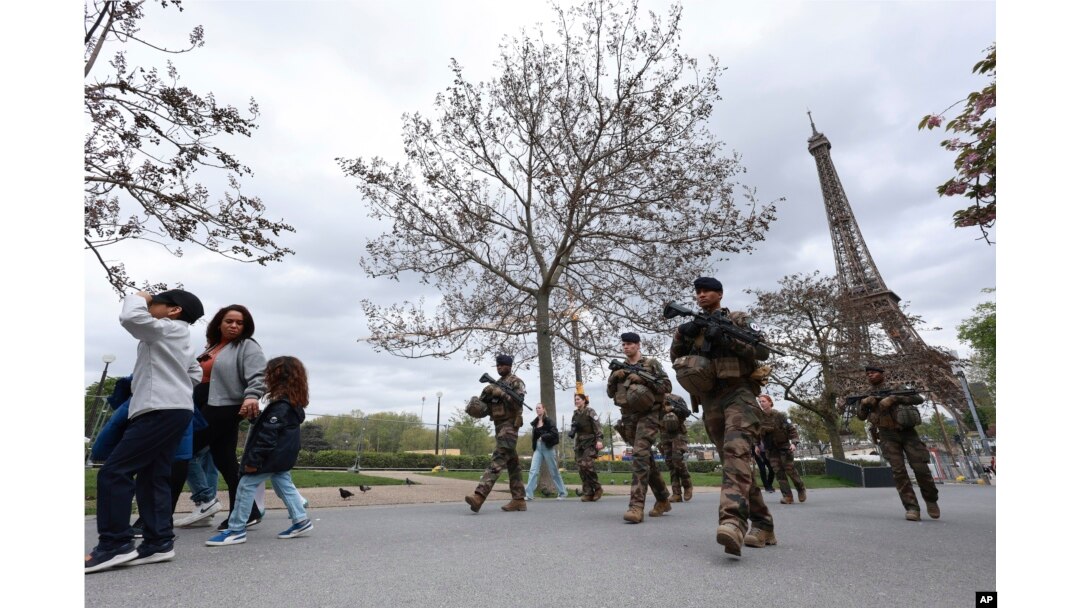 FILE - Soldiers patrol along a construction site for the upcoming Olympic Games, at the Trocadero gardens, April 11, 2024 in Paris, France.