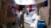 FILE - A health worker fumigates to help mitigate the spread of dengue at a home in Caranavi, Bolivia, March 2, 2023. 