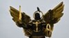 A crow sits on a sculpture of Kyiv's protector Archangel Michael on Independence Square on Nov. 1, 2023. 