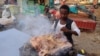FILE - A chef prepares a traditional dish of the Beja tribes at an open air cafe in Port Sudan, the capital of the Red Sea state in eastern Sudan, on Nov.14, 2023. U.N. food agencies warn of a coming hunger catastrophe in 2024 in the warring nation.
