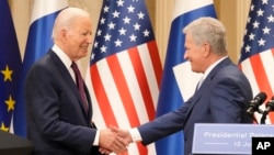 Finland's President Sauli Niinisto, right, shake hands with U.S. President Joe Biden in Helsinki, Finland, Thursday, July 13, 2023. 