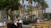People sit during the United Nations Climate Change Conference (COP28), in Dubai, United Arab Emirates, Dec. 3, 2023. 