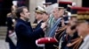 FILE - French President Emmanuel Macron awards a member of the special forces during a military ceremony in the courtyard of the Hotel National des Invalides in Paris, Feb. 19, 2024.