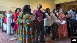 የአሜሪካ ዜጋ የመሆን ሥነ ስርዓት እያካሄዱ 