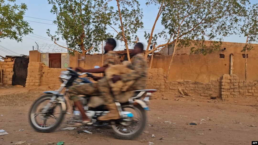 Sudanese army soldiers ride a motorcycle in Khartoum, on June 26, 2023. 