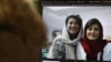 FILE - A woman looks at a computer screen with a photo of Iranian journalists Niloufar Hamedi and Elaheh Mohammadi, in Nicosia, Cyprus, Nov. 2, 2022. 