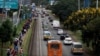 FILE - Cars and pedestrians line the road in Nairobi, Kenya, March 27, 2020. Road deaths have increased in Africa in the past decade, due to poor safety standards and lack of enforcement of safety laws.