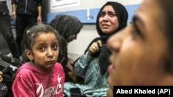Palestinianos feridos no hospital al-Shifa na cidade de Gaza, centro da Faixa de Gaza, após chegarem do hospital al-Ahlionde se registou uma explosão , 17 de outubro de 2023.