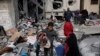 Palestinians salvage their belongings after an Israeli strike in Kahan Younis, Gaza Strip, Jan. 12, 2024. 