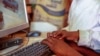 FILE - Two boys use a computer in Nairobi, Kenya, Sept. 29, 2021. Experts in digital technology and communications said on May 7, 2024, that African nations should pass laws to better protect the flow of data across borders while protecting people's privacy and safety.