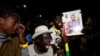 Supporters of Senegalese presidential candidate Bassirou Diomaye Faye celebrate early results showing that Faye is leading initial presidential election tallies, in Dakar, Senegal, March 24, 2024. 