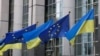 FILE - Flags of Ukraine fly in front of the EU Parliament building on the first anniversary of the Russian invasion, in Brussels, Belgium, Feb. 24, 2023. 