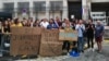 Protesters hold placards reading "Here, journalist in jail" and "Information behind bars" as they demonstrate in front of police headquarters in Marseille, France, Sept. 20, 2023, in support of jailed journalist Ariane Lavrilleux.