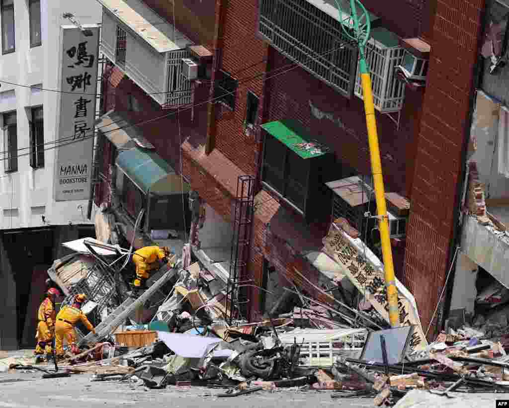 This handout from Taiwan's Military News Agency taken and released on April 3, 2024 shows military personnel aiding in rescue and relief efforts by searching for survivors in a damaged building in Hualien, after a major earthquake hit Taiwan's east.