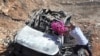 FILE - Samir Ayoub, uncle of three children who were killed by an Israeli airstrike, puts flowers on their car in the town of Ainata, a Lebanese border village with Israel in south Lebanon, Nov. 6, 2023. 