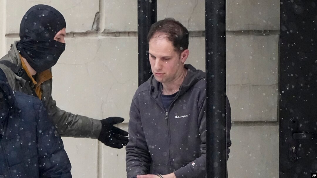 FILE - Wall Street Journal reporter Evan Gershkovich is escorted from court after a hearing in Moscow, Jan. 26, 2024. Arrests of Americans have become increasingly common as relations between Moscow and Washington sink to Cold War lows.