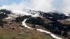 FILE - A strip of snow makes a ski slope in Saalbach, Austria, March 17, 2024. The U.N. weather agency is sounding “a red alert” about global warming last year and beyond.