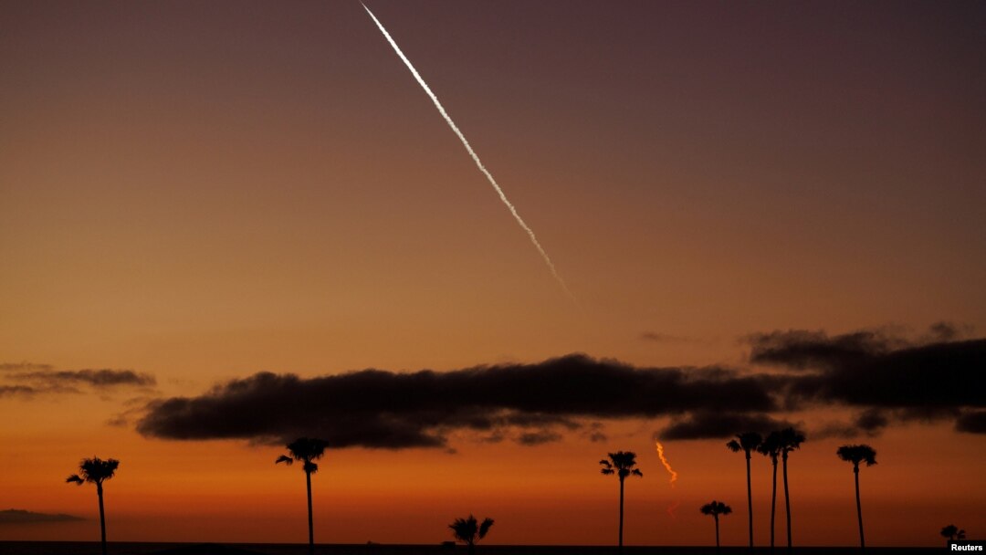 FILE - A SpaceX Falcon 9 rocket carrying 22 Starlink satellites to low-Earth orbit from Space Launch Complex 4 East at Vandenberg Space Force Base streaks over the Pacific Ocean near Encinitas, California, April 1, 2024. 