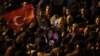 Supporters of Republican People's Party use their cellphones to watch the election results outside the headquarters of CHP, in Ankara, Turkey, May 14, 2023. 