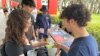 FILE - College students pass out literature to educate young voters at Florida Atlantic University, in Boca Raton, Florida, April 11, 2024.
