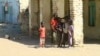 Displaced Sudanese children stand in the courtyard of a school, where their families took refuge, near Gadaref city in war-torn Sudan on March 6, 2024.