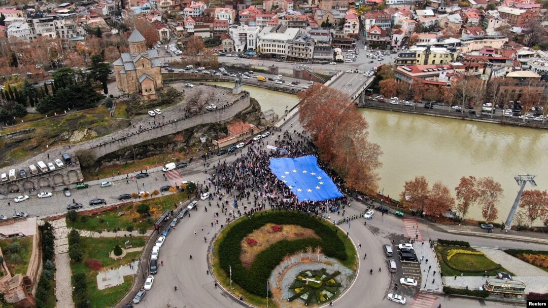 Participants carry a giant EU flag during a procession in support of Georgia's membership in the European Union in Tbilisi, Georgia, Dec. 9, 2023. 