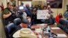 People in Idabel, Okla., call for the resignation of several McCurtain County officials at a county commissioners meeting April 17, 2023, after tapes with the officials' racist comments surfaced. (Christopher Bryan/Southwest Ledger via AP)