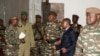 General Abdourahmane Tiani, center, who was declared as the new head of state of Niger by leaders of a coup, arrives to meet with ministers in Niamey, Niger, July 28, 2023. 