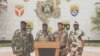 Kanali Ulrich Manfoumbi Manfoumbi (wapili kushoto) ambaye ni msemaji wa serikali ya mpito, akisoma taarifa kwenye televisheni ya Gabon, Septemba 7, 2023. Picha na Gabon 24 / AFP. 