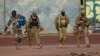 This undated photo provided by the French military shows three Russian mercenaries in northern Mali. Mali and its neighbors have long battled an Islamic extremist insurgency. Ruling juntas have turned to Russia's mercenary units for security assistance.