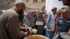 Palestinians line up for food distribution in Deir al Balah, Gaza, May 10, 2024. 
