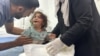 A Palestinian child, wounded in an Israeli strike on an area designated for displaced people, is assisted at a hospital, amid the ongoing conflict between Israel and Hamas, in Rafah in the southern Gaza Strip, May 26, 2024. 