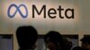 FILE - Attendees visit the Meta booth at a conference in San Francisco, California, March 22, 2023.