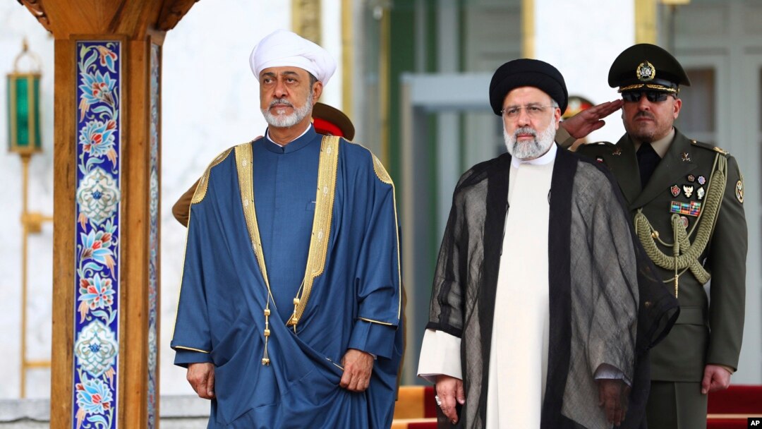 FILE - In this photo released by the office of the Iranian Presidency, Oman's Sultan Haitham bin Tariq Al Said, left, and Iranian President Ebrahim Raisi attend the official welcoming ceremony for Sultan Haitham at the Saadabad Palace in Tehran, May 28, 2023. 