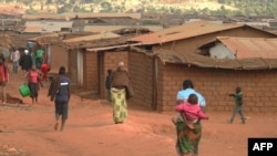 FILE - Refugees from various nationality walk through Dzaleka refugee camp in Dowa District Central region of Malawi on June 20, 2018.