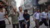 Coverage of conflict earned French photojournalist Laurence Geai a courage award from the International Media Women's Foundation. In 2014, she took this photo of an injured man fleeing a bombing in the Syrian city of Aleppo. (Laurence Geai/MYOP) 