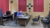 FILE - Marion County Record owner Eric Meyer edits an article in his office on Aug. 21. Meyer said that the suspension and resignation of the police chief who raided his office and home came too late. (Liam Scott/VOA)