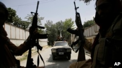 FILE - Taliban fighters patrol in Kabul, Afghanistan, on Aug. 19, 2021. 