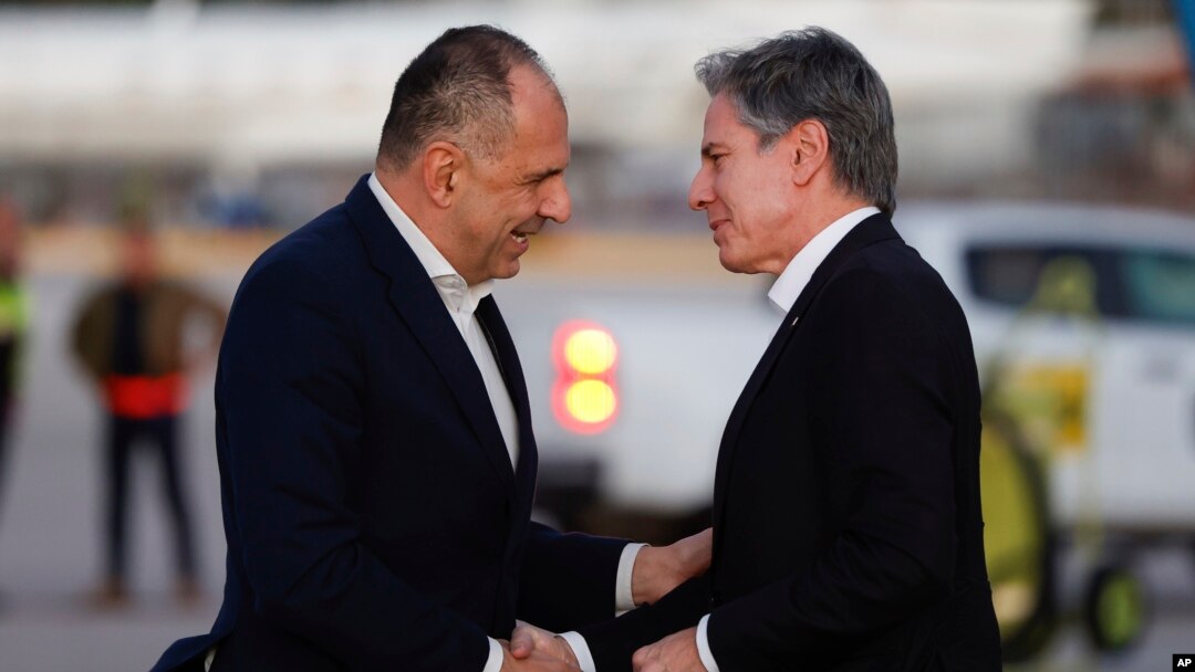 Greek Foreign Minister George Gerapetritis, left, greets U.S. Secretary of State Antony Blinken, as he arrives on the island of Crete, Greece, Jan. 6, 2024, during Blinken's latest trip to the Middle East. (Evelyn Hockstein/Pool Photo via AP)