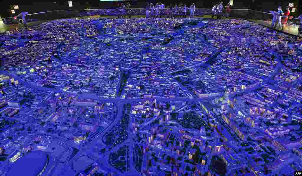 Visitors inspect the exhibition "The Model of Moscow" in Moscow, Russia. The architectural model represents 19,843 buildings inside the Garden Ring and partly outside it. 