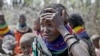 FILE - A woman waits for food distributed by the United States Agency for International Development in Kenya, July 23, 2022. Climate change and a growing world population may threaten global food security. Changes in agriculture, especially in Africa, may be the only way forward.