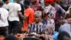 FILE - A woman counts money at Mile 12 International Market in Lagos, Nigeria, May 13, 2022.