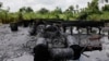 FILE - An abandoned illegal oil refinery is seen at the creeks of Bayelsa, Nigeria, May 18, 2013.