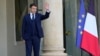 French President Emmanuel Macron waves goodbye to Georgia President Salome Zurabishvili after their talks at the Elysee Palace, Feb. 28, 2022 in Paris. 