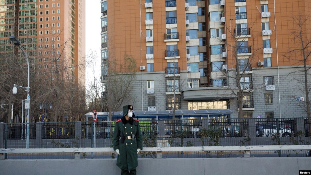 A member of the Chinese People's Armed Police Force wears a face mask as he keeps watch on a street amid COVID-19 outbreaks in Beijing, Dec. 1, 2022.