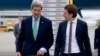U.S. Secretary of State John Kerry (L) walks to his car with Austria's Foreign Minister Sebastian Kurz as he arrives at Vienna International Airport, in Vienna, Austria, Oct. 15, 2014. 