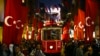 A tram rides past the spot of Sunday's explosion on Istanbul's popular pedestrian Istiklal Avenue in Istanbul, Turkey, Nov. 14, 2022.